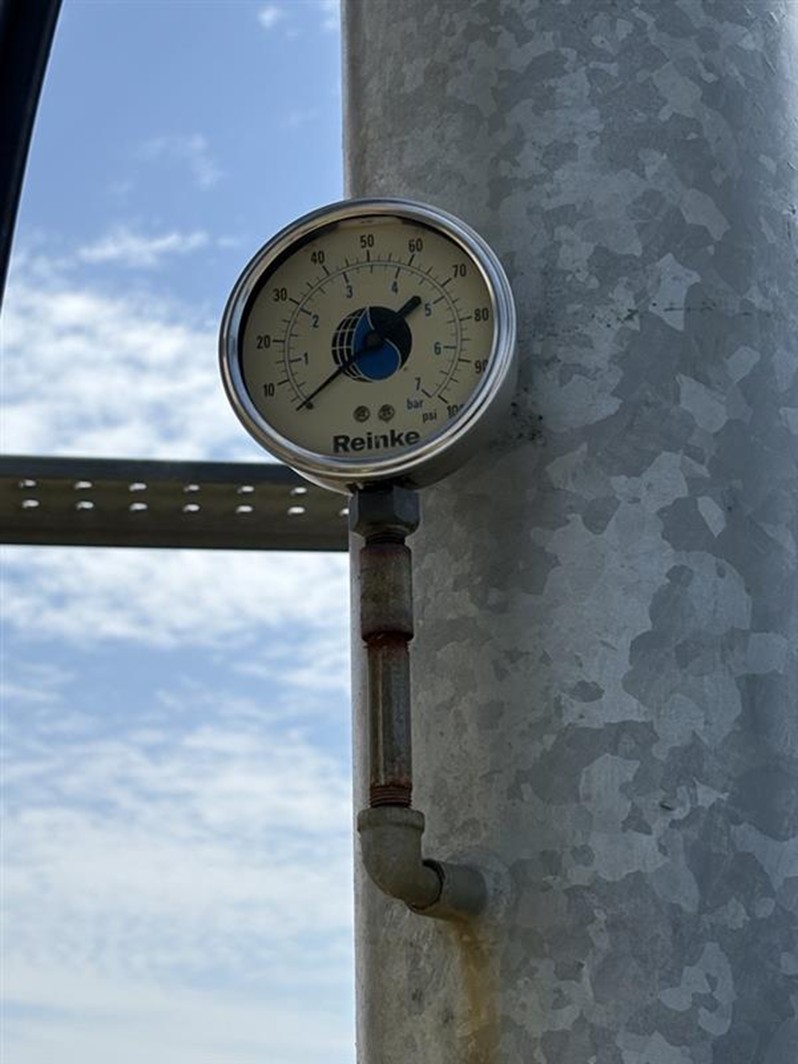A pressure gauge installed on a center pivot system. 